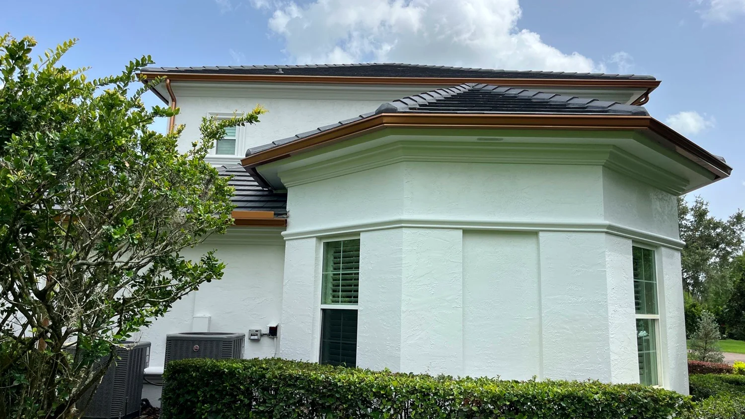 Seamless gutters and downspouts on a Brandon, FL home roofline