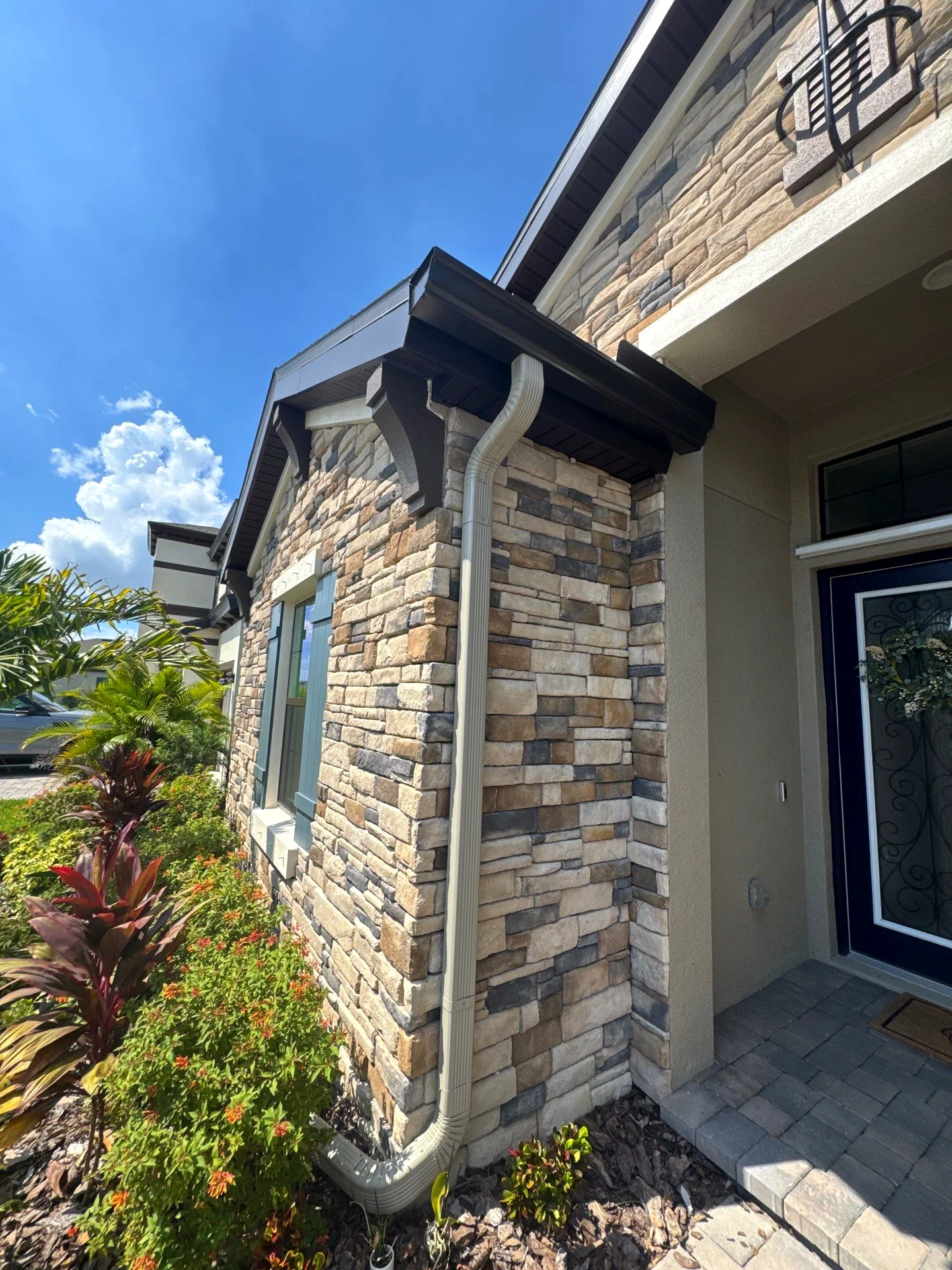 Two-story home with new gutters installed in Valrico, Florida