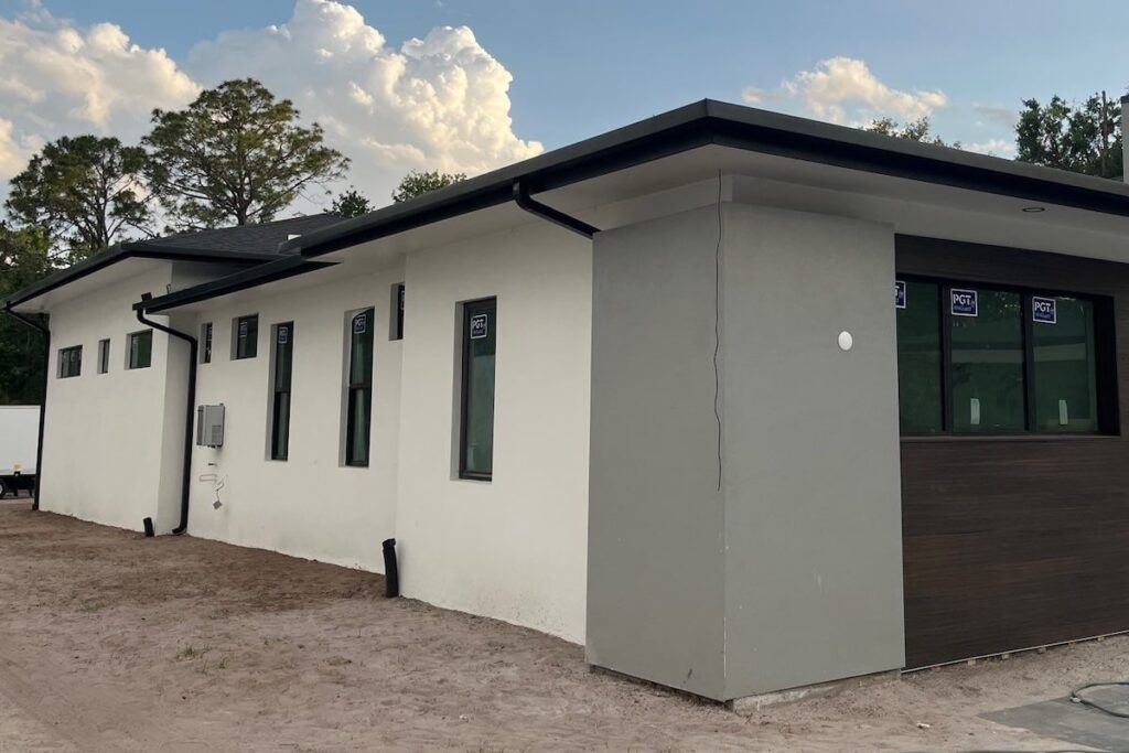 modern stucco home with black seamless gutters in tampa