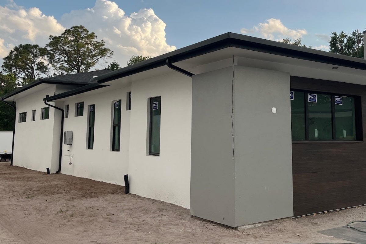 modern stucco home with black seamless gutters in tampa